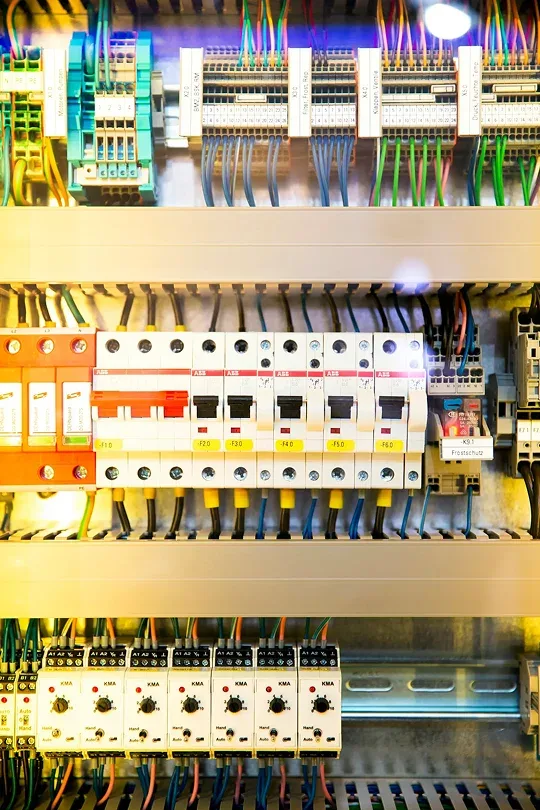 Industrial electrician inspecting electrical distribution equipment
